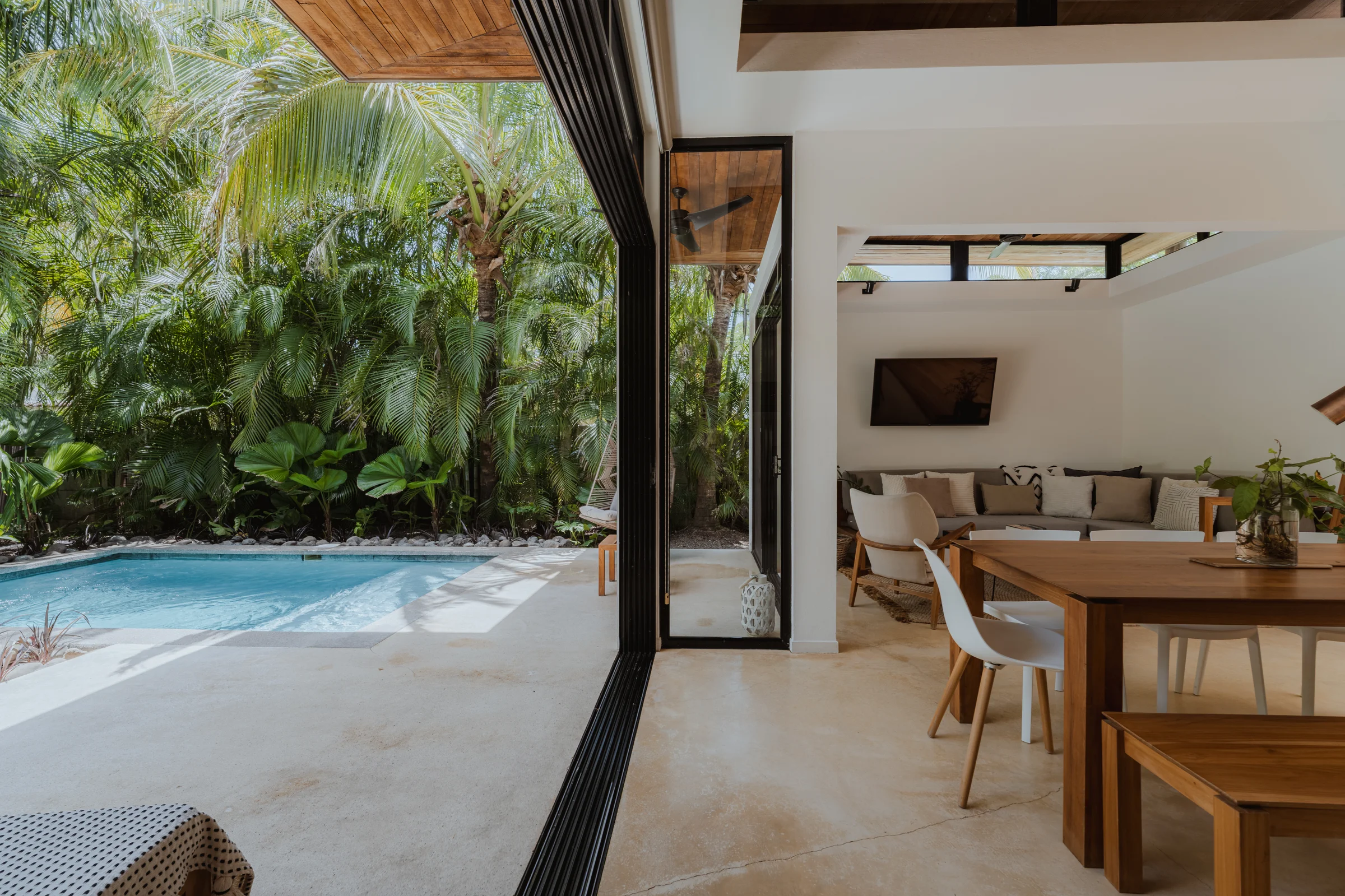 Open villa living area looking out to a pool at Nalu Nosara